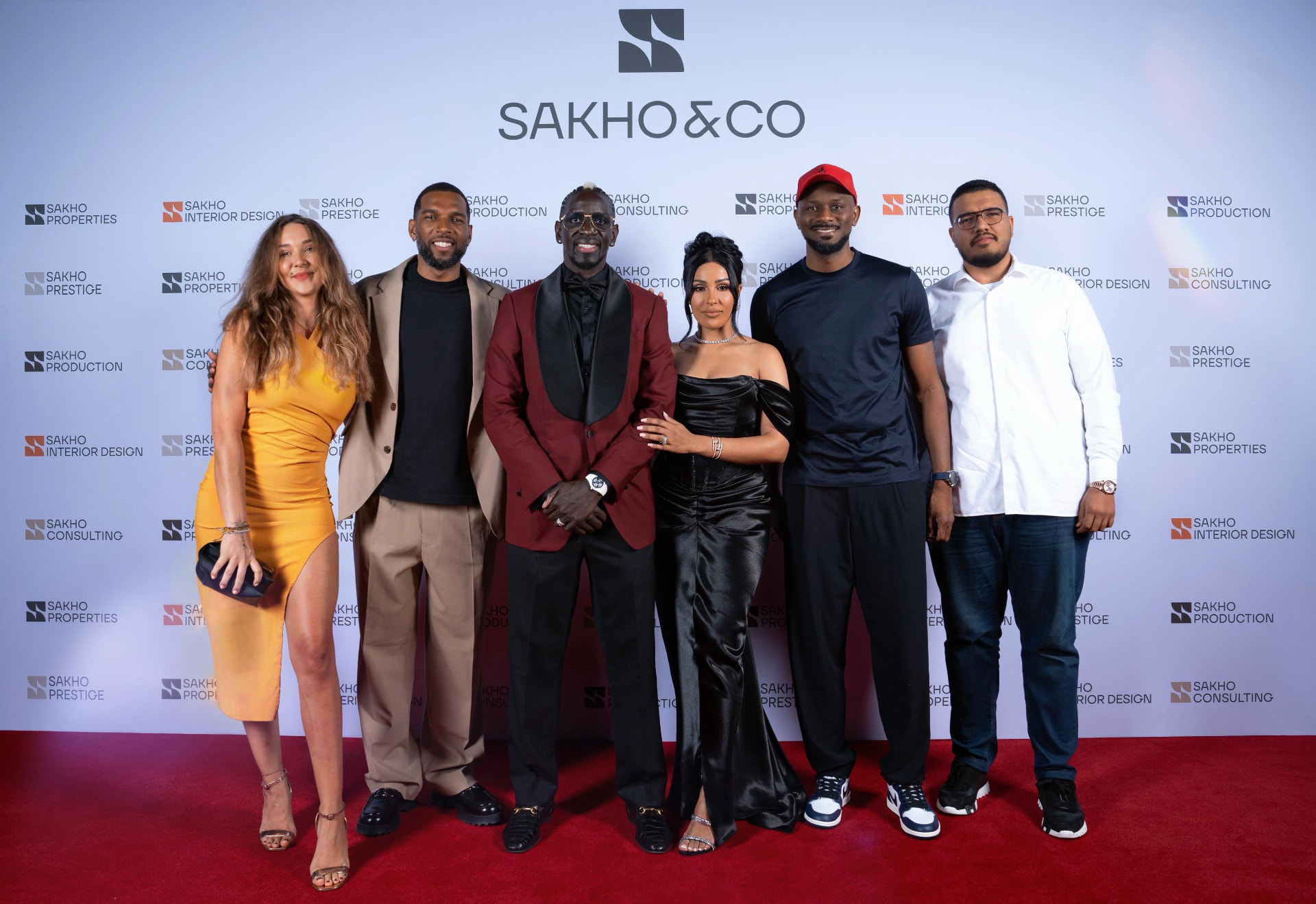 Guests on the red carpet in front of the Sakho&Co event wall in Dubai
